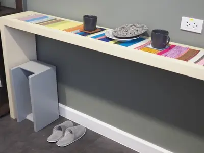 a table with a pair of shoes under it at Chomm House in Bangkok