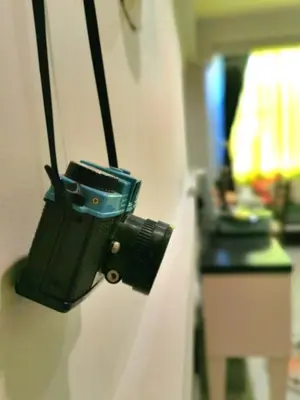 a camera is hanging on a wall at Chomm House in Bangkok