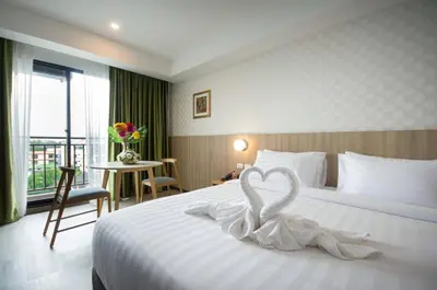 a hotel room with a bed with a heart decoration on it at Marsi Hotel @ Bangchak in Bangkok