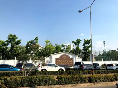 a parking lot with cars parked in front of a sign at Popular CondoT8@IMPACT Arena in Nonthaburi