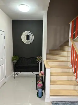 a living room with a staircase with a black wall at M Villa @ Impact Muangthongthani in Ban Bang Phang