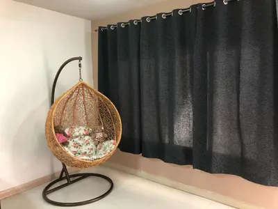 a wicker basket sitting in front of a black curtain at M Villa @ Impact Muangthongthani in Ban Bang Phang