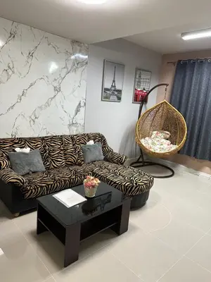 a living room with a couch and a table at M Villa @ Impact Muangthongthani in Ban Bang Phang