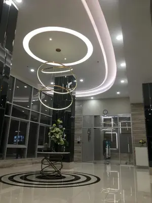 a lobby with a chandelier in a building at Supalai Rama9 Monthly in Bangkok