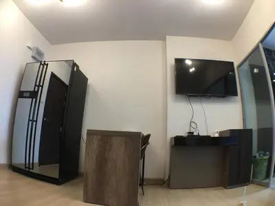 a room with a black refrigerator and a flat screen tv at Supalai Rama9 Monthly in Bangkok