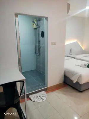 a bathroom with a glass shower with a bed and a bed at Bed By Boat @Nonthaburi Pier in Nonthaburi