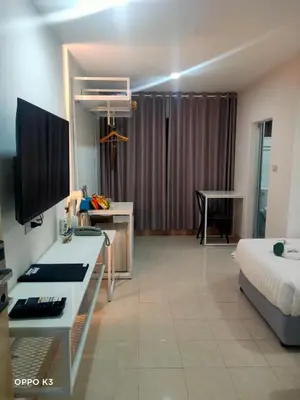 a hotel room with a bed and a desk with a computer at Bed By Boat @Nonthaburi Pier in Nonthaburi