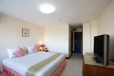 a bedroom with a bed and a flat screen tv at D-haus Ladprao Residence in Bangkok