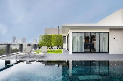 a swimming pool on the roof of a building at Walton Suites Sukhumvit in Bangkok