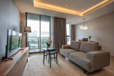 a living room with a couch and a table at Walton Suites Sukhumvit in Bangkok