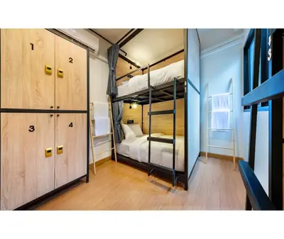 a bedroom with two bunk beds and a closet at Siam Subway Hostel and Café in Bangkok
