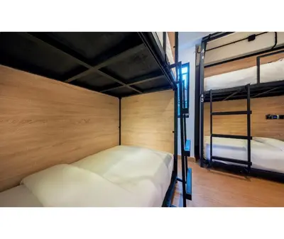 a room with two bunk beds in it at Siam Subway Hostel and Café in Bangkok