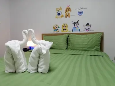 two stuffed animals are standing on a bed at ruamsab apartment1 in Bangkok