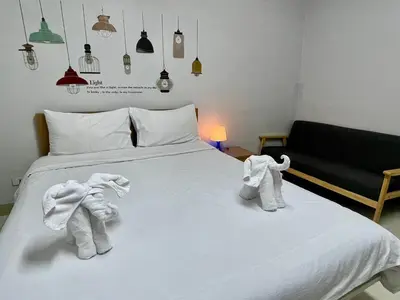 a bedroom with two towels on a bed at ruamsab apartment1 in Bangkok