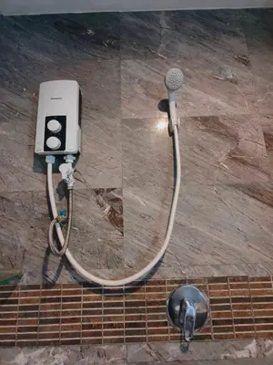 a shower with a hose hooked up to a microphone at Cloud no 3 Serene Oasis King Bed in BKK Heart in Bangkok