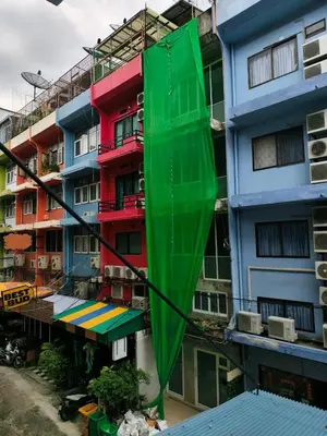 a green umbrella on the side of a building at Cloud no 3 Serene Oasis King Bed in BKK Heart in Bangkok