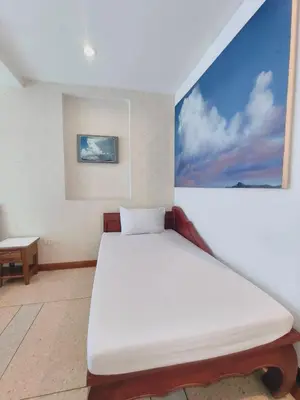 a white bed in a room with a painting on the wall at Cloud no 3 Serene Oasis King Bed in BKK Heart in Bangkok