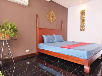 a bedroom with a bed with blue and red sheets at Old Spice 4 Downtown Serenity Luxurious Oasis BKK in Bangkok