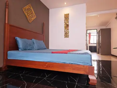 a bedroom with a wooden bed with blue pillows at Old Spice 4 Downtown Serenity Luxurious Oasis BKK in Bangkok