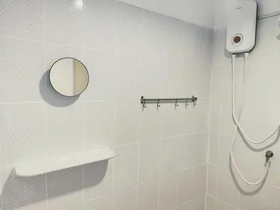 a bathroom with a shower and a mirror at Lumphini 9 Haven Urban Retreat Bright Room in Bangkok