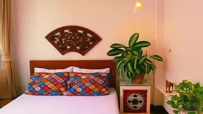 a bedroom with a bed and a potted plant at Lumphini 9 Haven Urban Retreat Bright Room in Bangkok