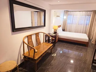a room with a bed and a chair and a mirror at Old Sрice 2 Urban Studio Oasis Central Bangkok MRT in Bangkok