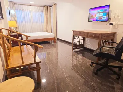 a room with a desk and chairs and a television at Old Sрice 2 Urban Studio Oasis Central Bangkok MRT in Bangkok