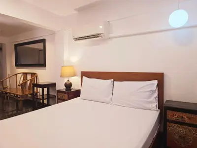 a bedroom with a bed and a table and a chair at Old Sрice 2 Urban Studio Oasis Central Bangkok MRT in Bangkok
