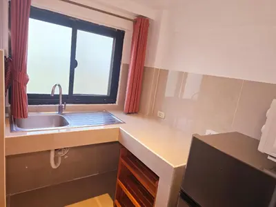 a kitchen with a sink and a window at Old Sрice 2 Urban Studio Oasis Central Bangkok MRT in Bangkok