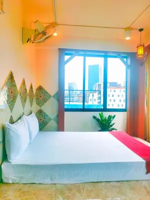 a bedroom with a large white bed with a window at Sky bedroom with a smooth life view in Bangkok
