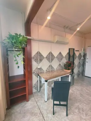 a table and a chair in a room at Sky bedroom with a smooth life view in Bangkok