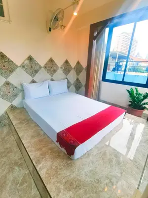 a bed in a room with a large window at Sky bedroom with a smooth life view in Bangkok