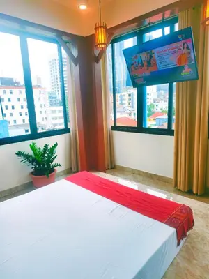 a bedroom with a large bed with a tv on the wall at Sky bedroom with a smooth life view in Bangkok