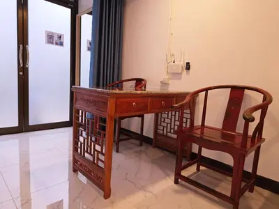 a wooden desk and a chair in a room at Old Sрice 1 Sizzling Studio Queen Twin - No Stairs in Bangkok