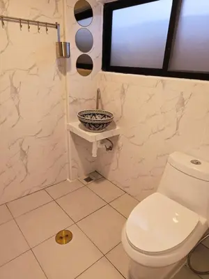 a white bathroom with a toilet and a window at Old Sрice 1 Sizzling Studio Queen Twin - No Stairs in Bangkok