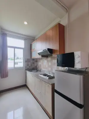 a kitchen with a white refrigerator and a window at Cloud no 4 Green n Quiet Heart BKK With a Balcony in Bangkok
