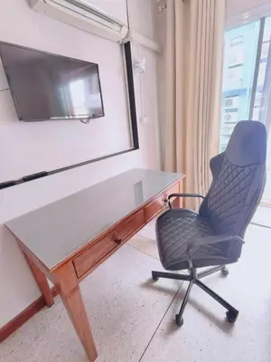 a desk with a chair and a tv on a wall at Cloud no 4 Green n Quiet Heart BKK With a Balcony in Bangkok