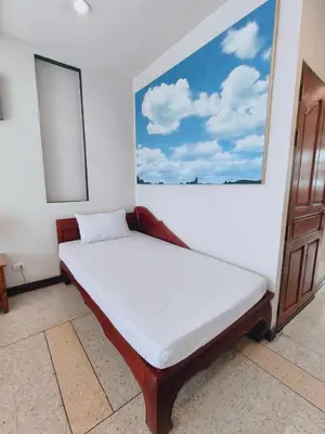 a bed in a room with a large window at Cloud no 4 Green n Quiet Heart BKK With a Balcony in Bangkok