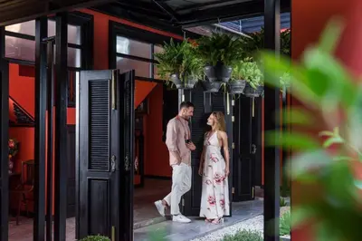 a man and a woman standing outside of a building at DE Phanakron Boutique Hotel in Bangkok