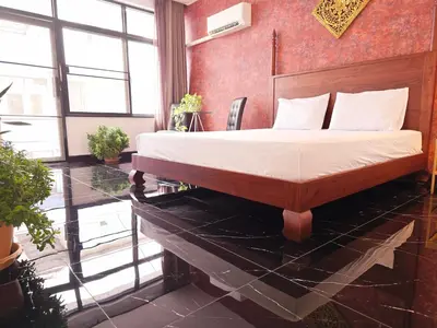 a bedroom with a bed and a glass table at Old Sрice 5 Elegant Tranquility Your BKK Haven in Bangkok