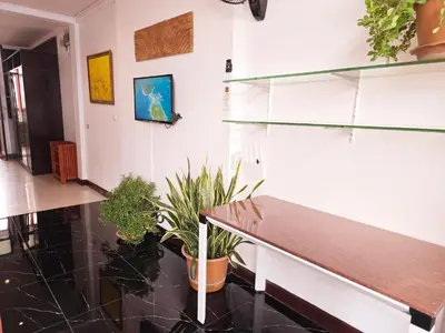 a hallway with a bench and potted plants at Old Sрice 5 Elegant Tranquility Your BKK Haven in Bangkok