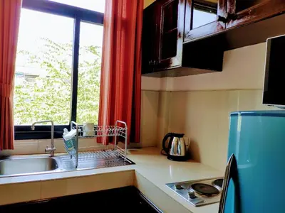 a small kitchen with a sink and a window at Old Sрice 3 Vintage Elegance in the Heart of BKK in Bangkok
