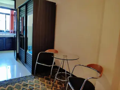 a table and chairs in a room with a window at Old Sрice 3 Vintage Elegance in the Heart of BKK in Bangkok