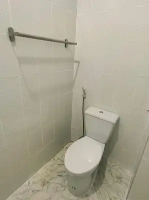 a bathroom with a white toilet in a room at Lumphini 5 Train station center EnSuite Aircon in Bangkok