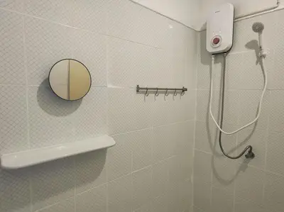 a bathroom with a shower and a mirror at Lumphini 5 Train station center EnSuite Aircon in Bangkok