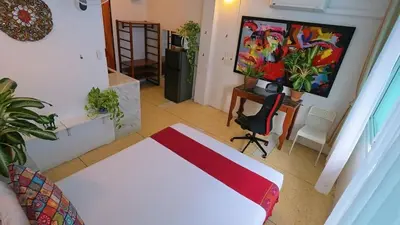 a living room with a white table and a painting at Lumphini 5 Train station center EnSuite Aircon in Bangkok