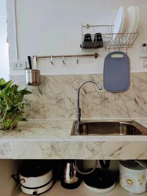a kitchen counter with a sink and pots and pans at Lumphini 5 Train station center EnSuite Aircon in Bangkok