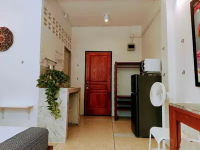 a kitchen with a red door and a refrigerator at Lumphini 5 Train station center EnSuite Aircon in Bangkok