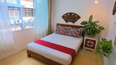 a small bed in a room with a window at Lumphini 5 Train station center EnSuite Aircon in Bangkok