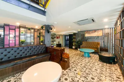 a waiting room with a toilet and a bench at BB Glass House บีบี กลาสเฮ้าส์ in Bangkok